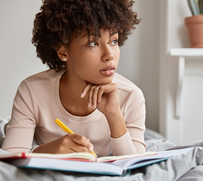 Learn More about what it means to be trauma informed. Girl looks off into the distance.